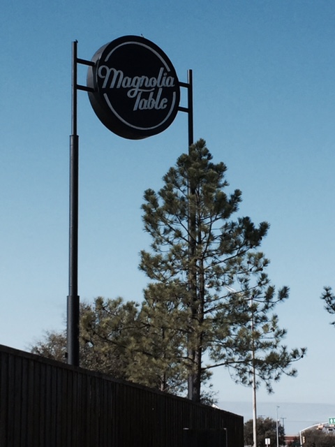 Magnolia Table exterior with sign and evergreen tree. #magnoliatable