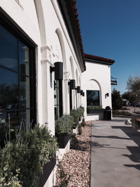 Magnolia Table restaurant black and white exterior and window boxes with greenery. #magnolia #magnoliatble #restaurant #fixerupper