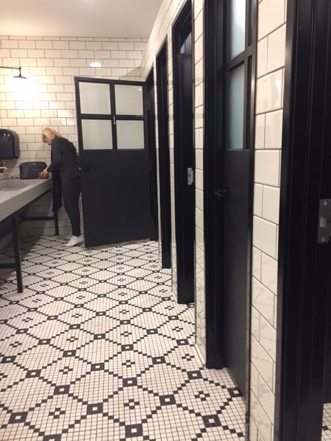 Magnolia Table restaurant restroom area with black and white tile. #magnoliatable #fixerupper #blackandwhite