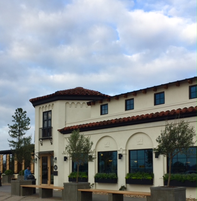 Magnolia Table restaurant in Waco exterior with black and white decor and window boxes at the arched windows. #magnoliatable #restaurant #fixerupper #Waco #JoannaGaines