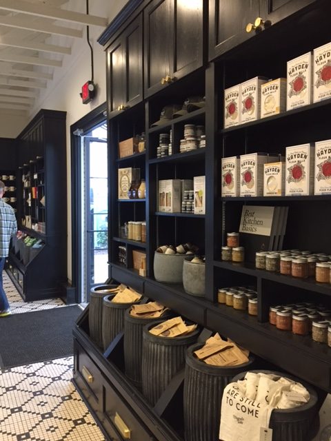 Magnolia Table gift shop area with black shelves and farmhouse style. #fixerupper #magnoliatable 3blackandwhite