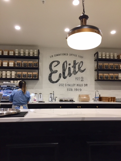 Magnolia Table restaurant coffee bar with Elite Cafe sign and long marble bar with vintage style lighting. #fixerupper #magnoliatable #restaurant #bar #EliteCafe