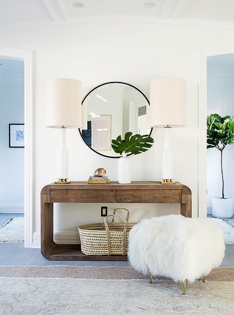 Modern farmhouse decor in a mid-century modern home. A few notes of family-friendly design: rounded edges on the console, a Moses basket (perfect for a sleeping baby or a pile of blankets), and a Tibetan fleece stool that takes soft to a new level. #livingroom #homedecor #furniture #consoletable #modernfarmhouse #modernrustic #allwhitedecor