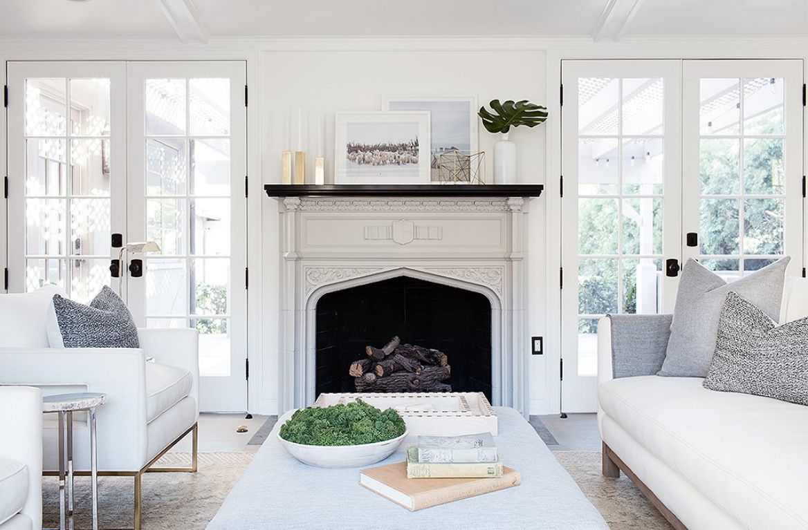 Modern rustic luxe farmhouse living room with midcentury modern style. Vintage fireplace and white linen upholstery mix with Chantilly Lace painted walls. #livingroom #whitelivingroom #chantillylace #modernrustic #whiteonwhite