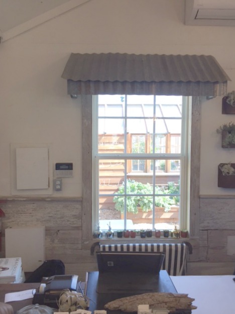 Corrugated metal awning inside the garden shop at Magnolia Silos in Waco. #magnoliamarket #silos #awning #garden