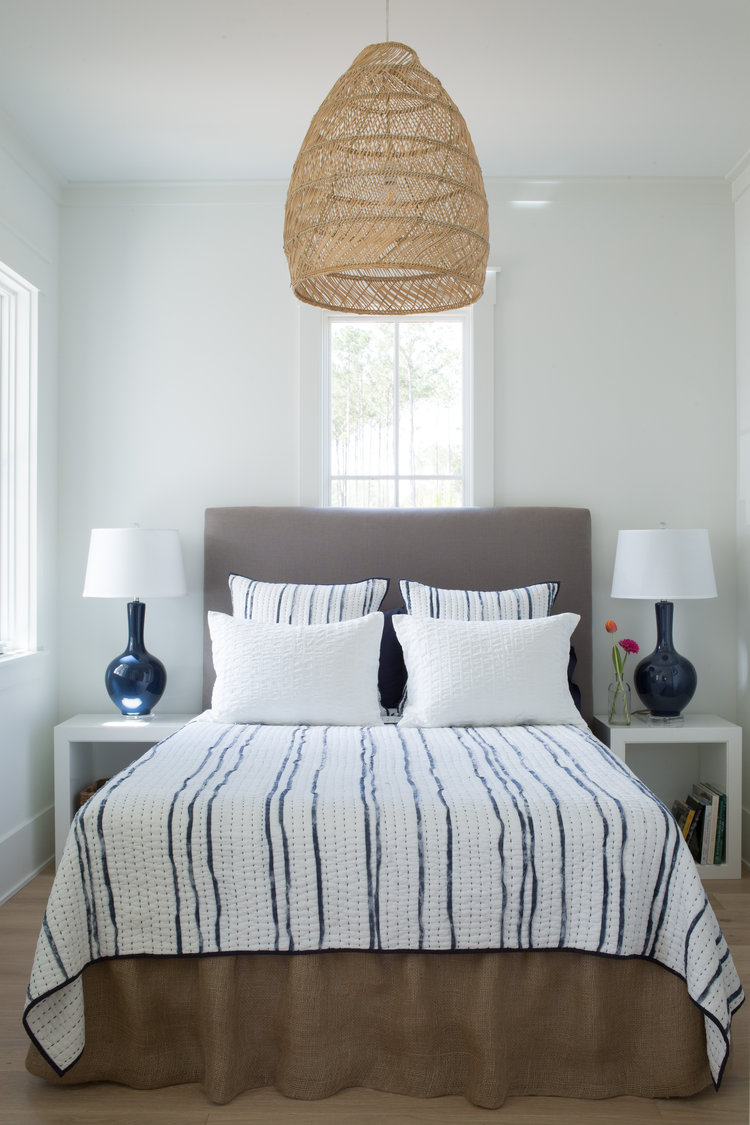 Benjamin Moore White OC-151 on walls of a coastal bedroom with navy blue accents (Lisa Furey). Come score more Coastal Cottage Inspo, Paint Colors & Whimsy Quotes Now!