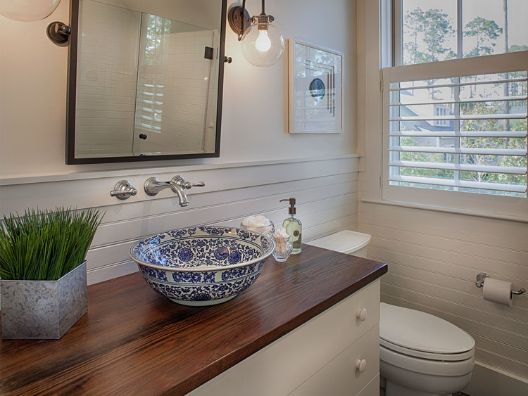 Coastal bathroom. Board and batten coastal cottage in Palmetto Bluff with modern farmhouse interior design by Lisa Furey.