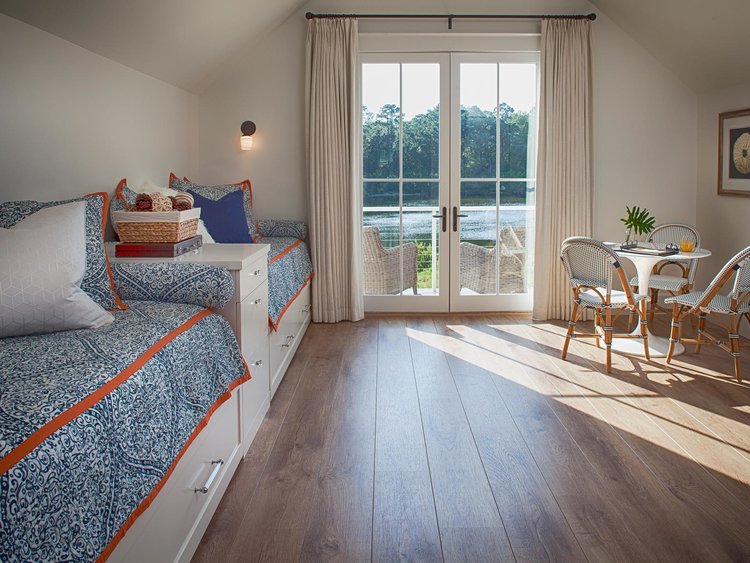 Blue bunk room in carriage house.Board and batten coastal cottage in Palmetto Bluff with modern farmhouse interior design by Lisa Furey.