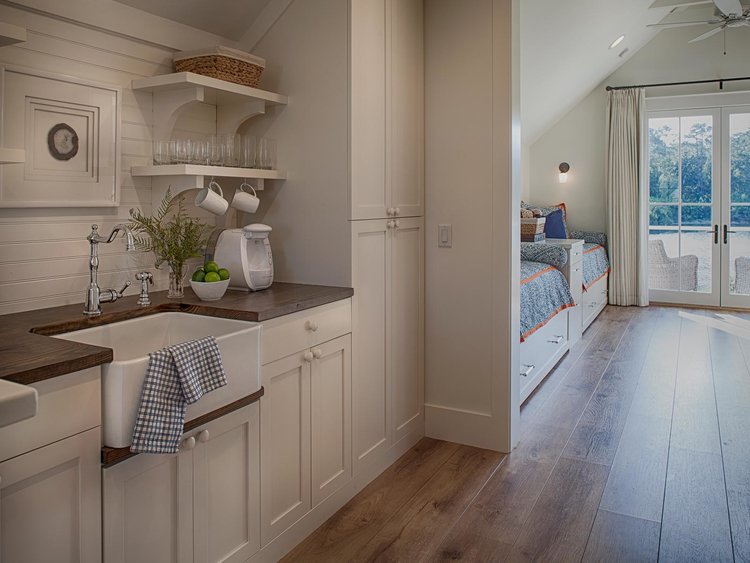 BM White OC-151. Kitchen in carriage house. Board and batten coastal cottage in Palmetto Bluff with modern farmhouse interior design by Lisa Furey.
