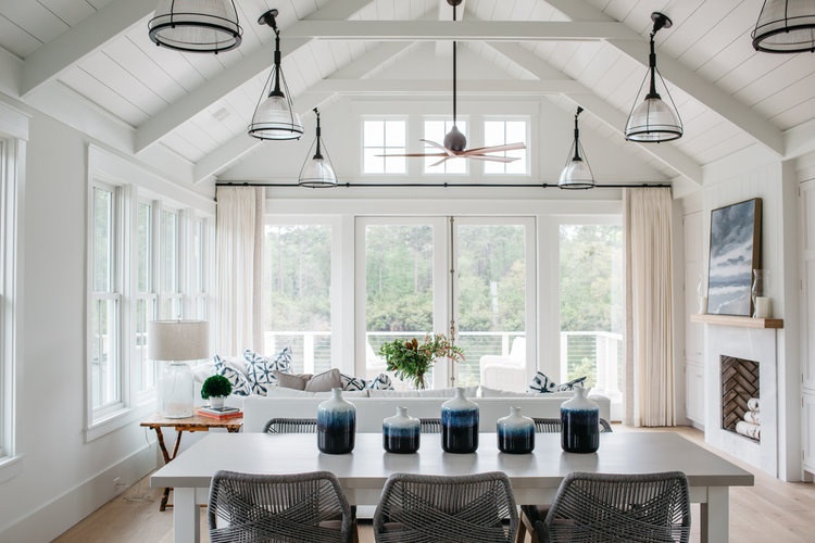 Dining room and great room in a board and batten coastal cottage in Palmetto Bluff with modern farmhouse interior design by Lisa Furey. #coastalstyle #shiplap #greatroom #waterfronthome #coastalcottage #interiordesign