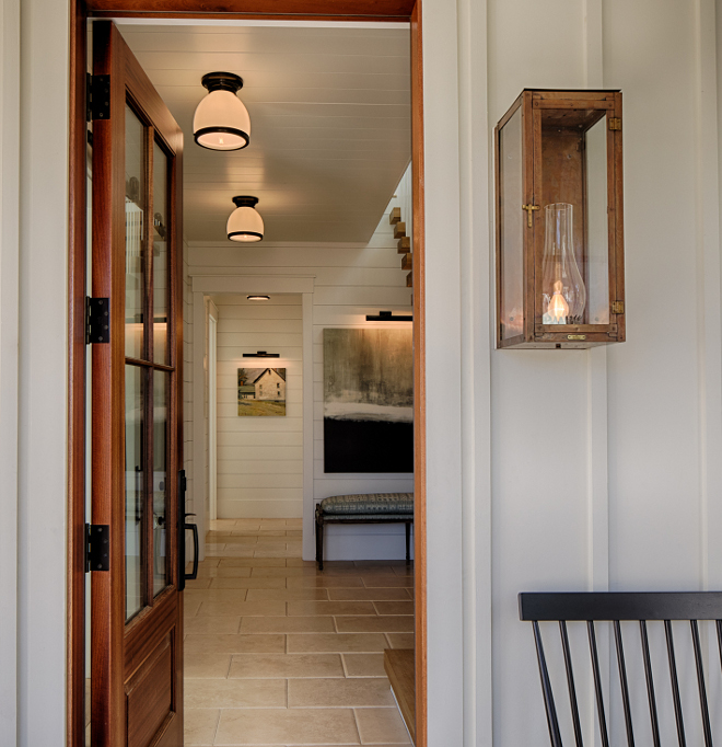 Front porch. Board and batten coastal cottage in Palmetto Bluff with modern farmhouse interior design by Lisa Furey.