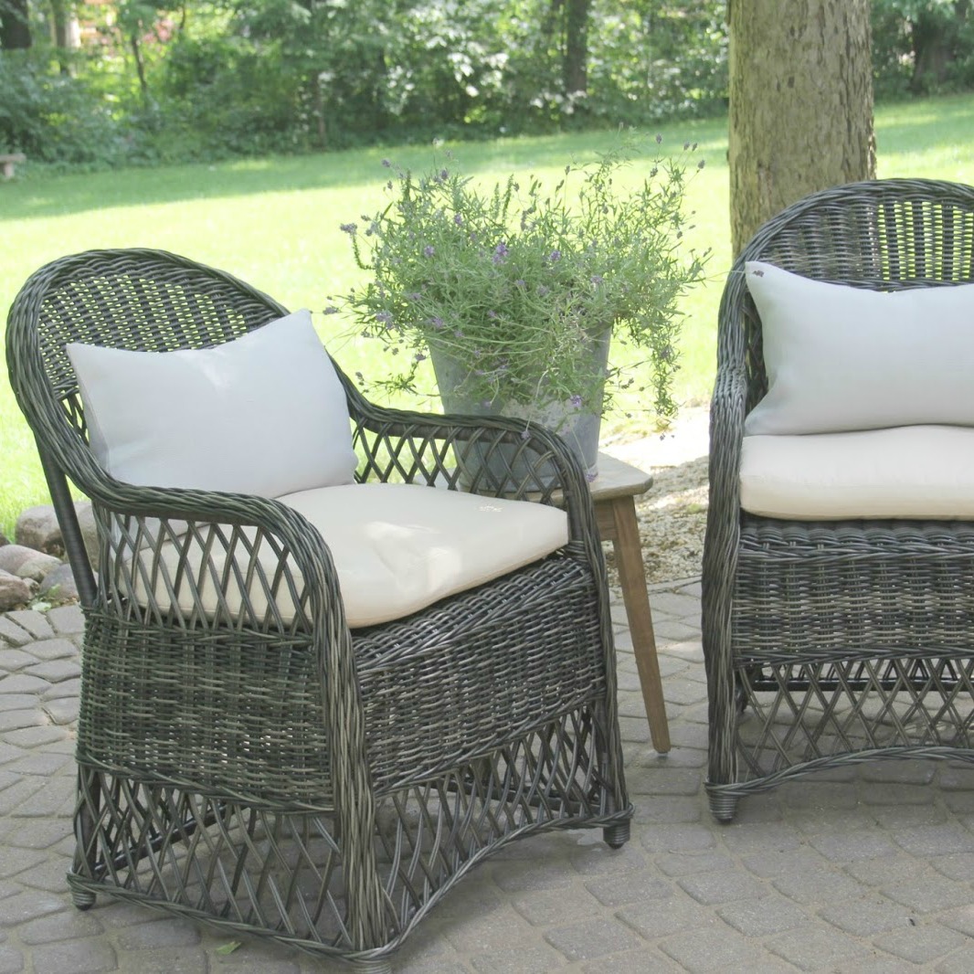 Grey rattan patio chairs with light blue linen lumbar pillows create a peaceful conversation area outdoors - Hello Lovely Studio. Come explore 3 looks for a modern outdoor oasis!