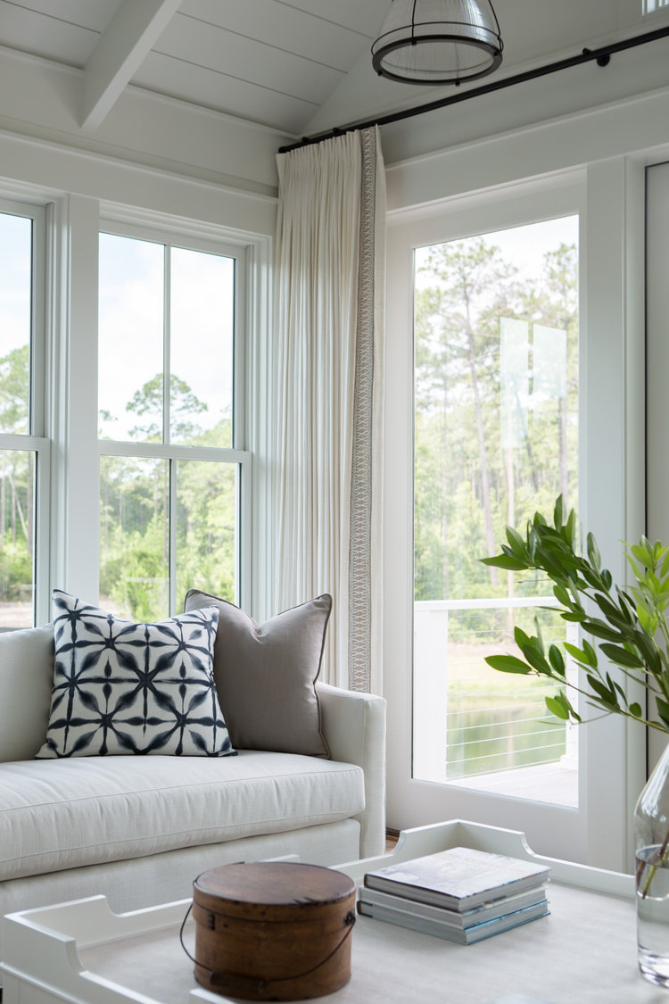 Blue and white great room in a board and batten coastal cottage in Palmetto Bluff. Modern farmhouse interior design by Lisa Furey. #greatroom #blueandwhite #coastalstyle #interiordesign