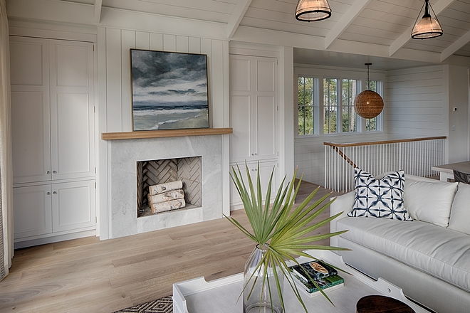 Fireplace in living room. Board and batten coastal cottage in Palmetto Bluff with modern farmhouse interior design by Lisa Furey.