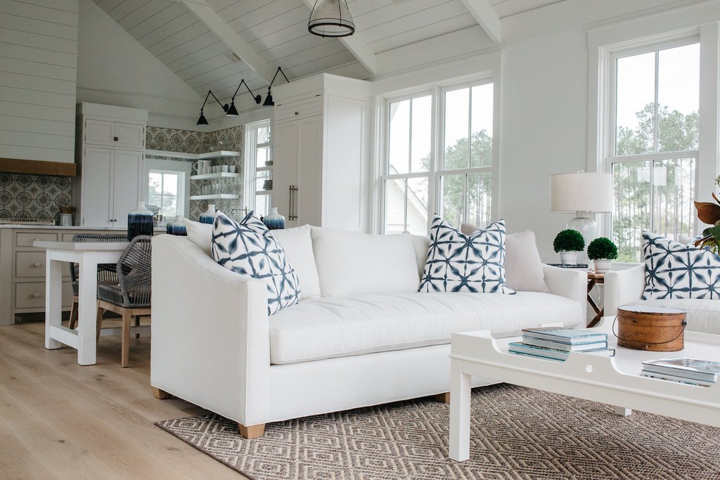 White living room. Board and batten coastal cottage in Palmetto Bluff with modern farmhouse interior design by Lisa Furey.