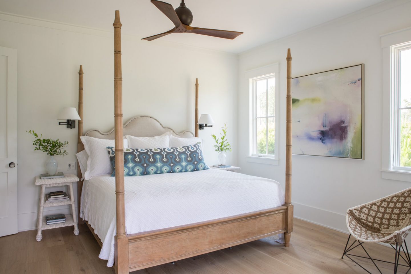 Master bedroom with poster bed. Board and batten coastal cottage in Palmetto Bluff with modern farmhouse interior design by Lisa Furey.