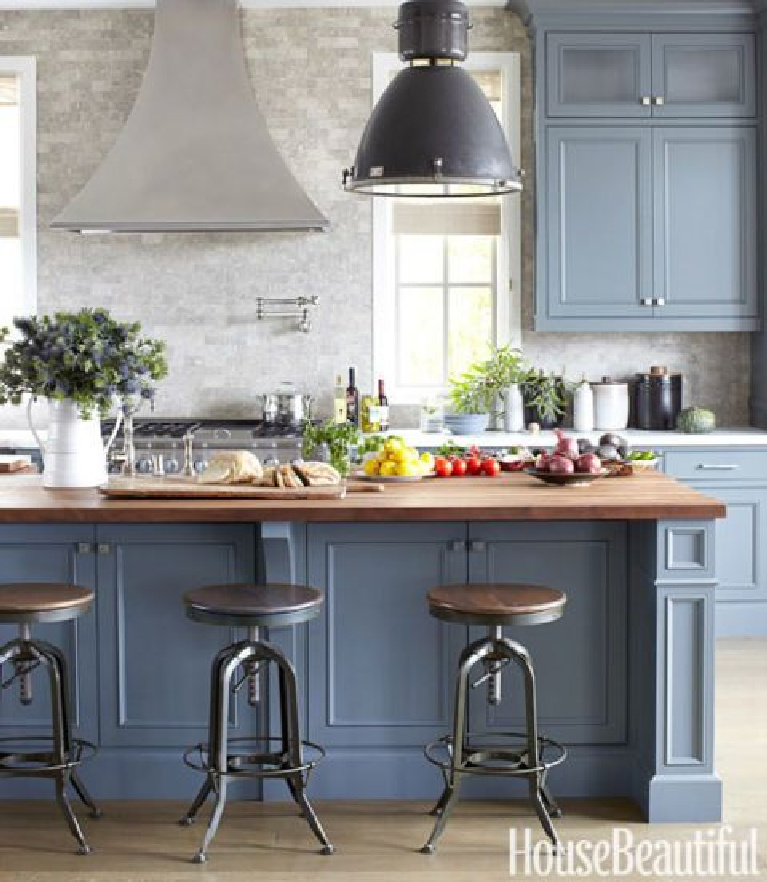 The kitchen is a favorite place to host casual lunches and dinners. "The mahogany-topped island can easily fit 12 stools," Come see 36 Best Beautiful Blue and White Kitchens to Love! #blueandwhite #bluekitchen #kitchendesign #kitchendecor #decorinspiration #beautifulkitchen