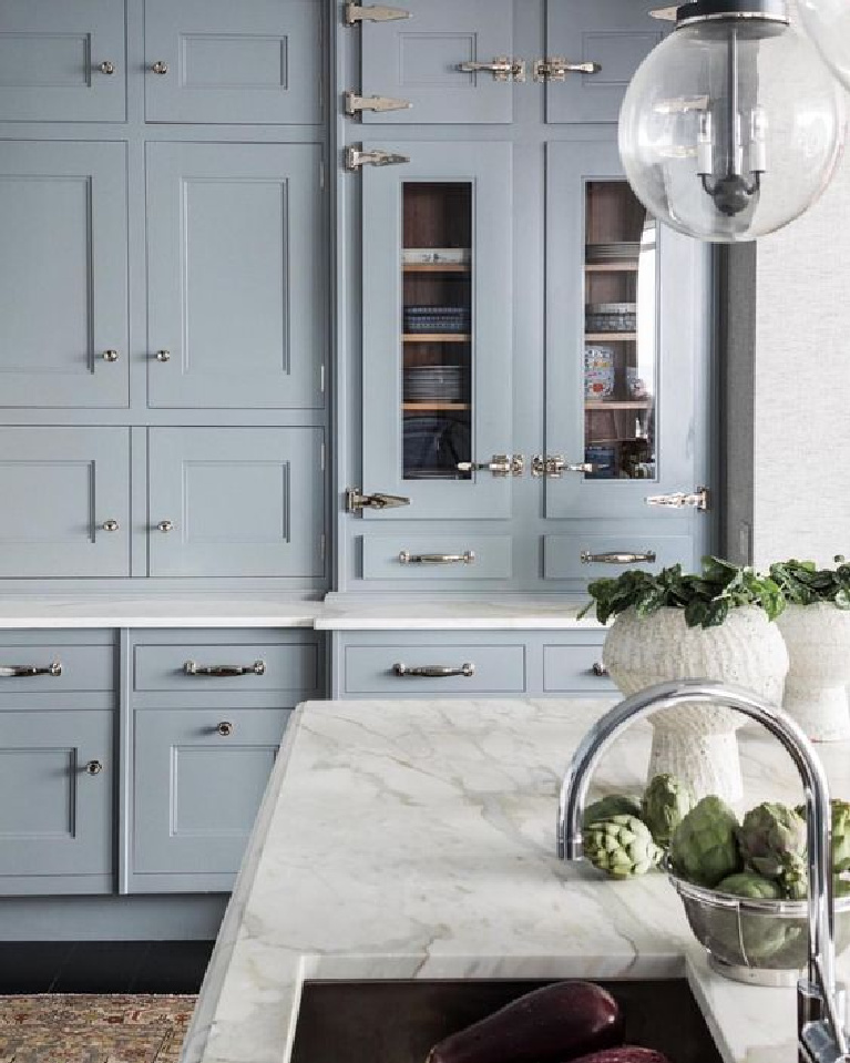 Light blue kitchen cabinets, white marble countertop, and dramatic cabinet hardware. Come see 36 Best Beautiful Blue and White Kitchens to Love! #blueandwhite #bluekitchen #kitchendesign #kitchendecor #decorinspiration #beautifulkitchen #kitchendesign #bluecabinets #bluekitchen