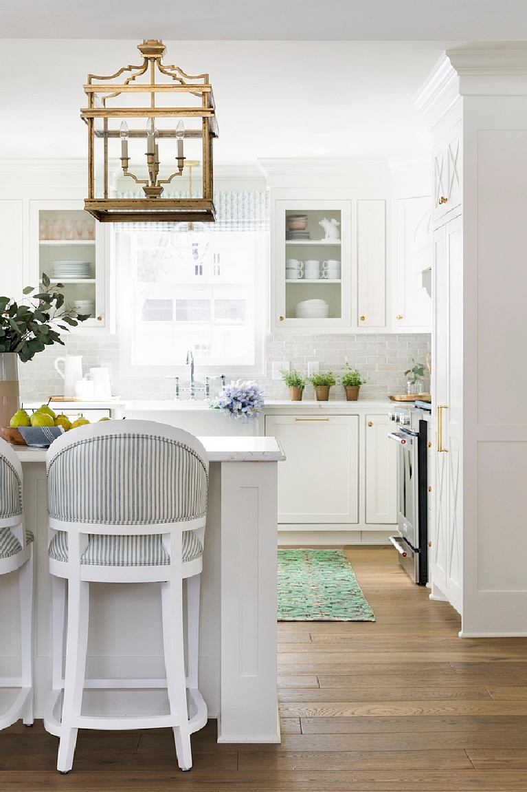 Soft white kitchen with white terracotta subway tile backsplash white quartz countertop and white farmhouse sink. Come see 36 Best Beautiful Blue and White Kitchens to Love! #blueandwhite #bluekitchen #kitchendesign #kitchendecor #decorinspiration #beautifulkitchen