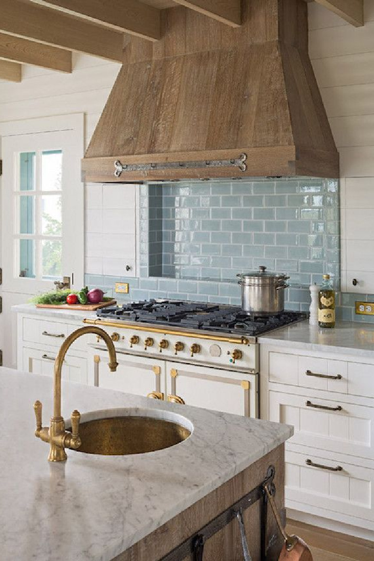 Turquoise blue subay tile behind range in gorgeous kitchen with rustic range hood. Come see 36 Best Beautiful Blue and White Kitchens to Love! #blueandwhite #bluekitchen #kitchendesign #kitchendecor #decorinspiration #beautifulkitchen