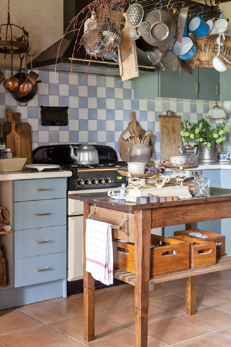 Blue and white tiles in a kitchen found in a French market and a wooden table once used for drying cheeses. “Our interior decoration is not something we managed in a short period,” says Clementine, “but is the result of a lifetime of collecting nice brocante furniture and vintage items.” 