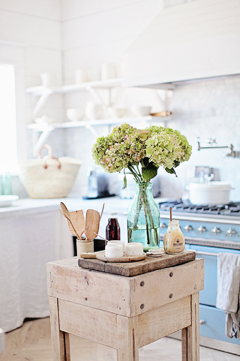 French farmhouse kitchen with blue Lacanche range, butcher block work table, hydrangea, and glorious white - Dreamywhites. #frenchfarmhouse 