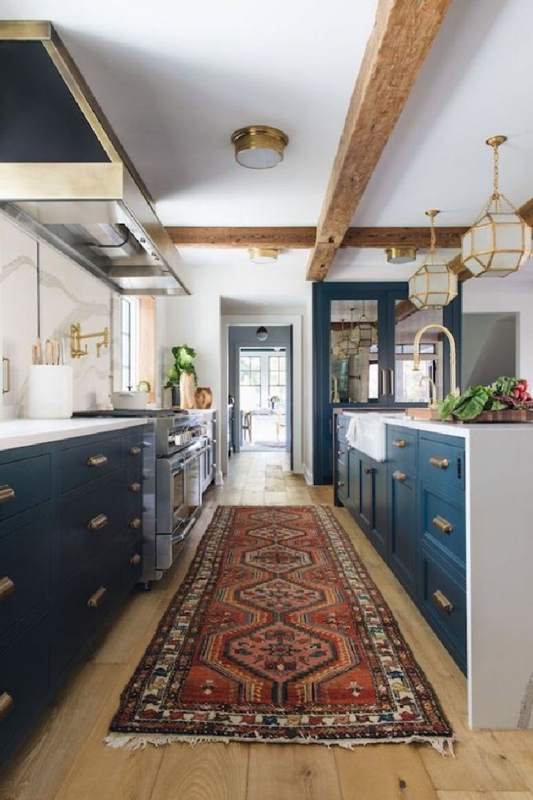 Blue kitchen with waterfall island and beamed ceiling. Come see 36 Best Beautiful Blue and White Kitchens to Love! #blueandwhite #bluekitchen #kitchendesign #kitchendecor #decorinspiration #beautifulkitchen