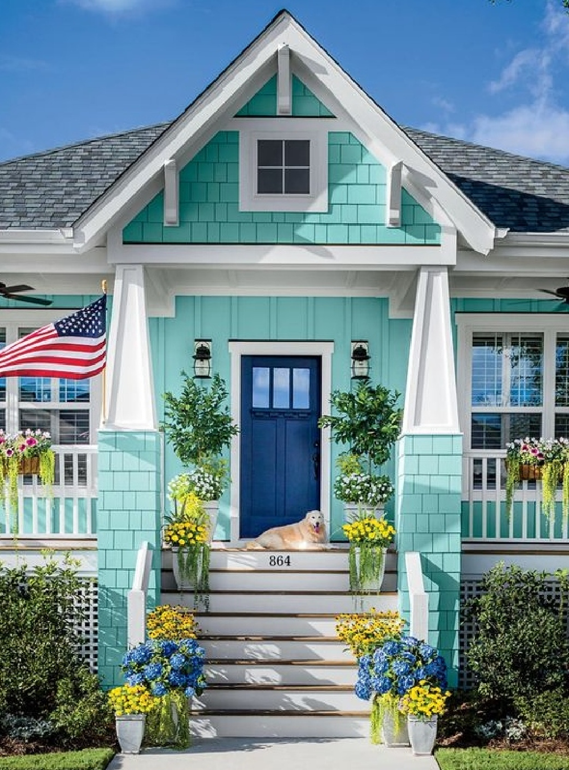 Bright turquoise cottage exterior with royal blue front door - Completely Coastal. #coastalcottage #turquoise