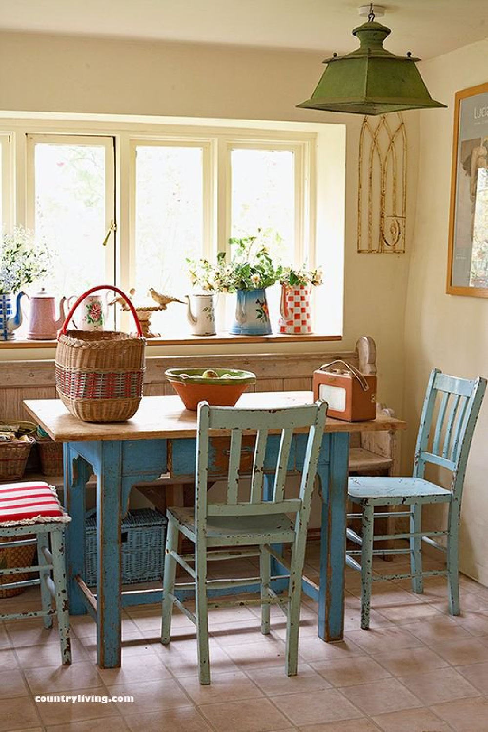 Lovely breakfast nook with turquoise chairs in a farmhouse kitchen - Country Living. #breakfastnook #turquoise