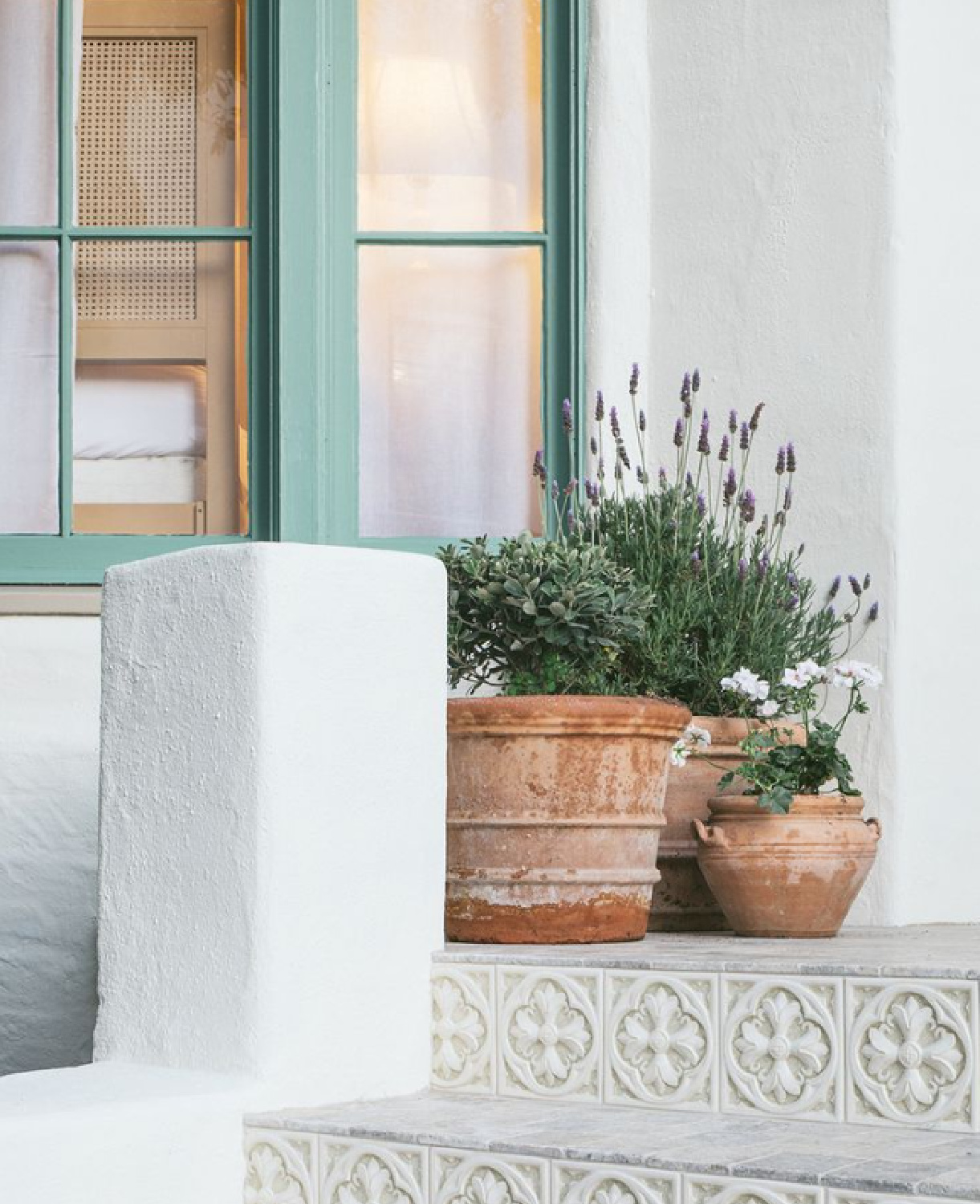 Lovely blue-green window trim (SW Parisian Patina) on a white stucco home - Hearth Homes Interiors. #parisianpatina #paintcolors