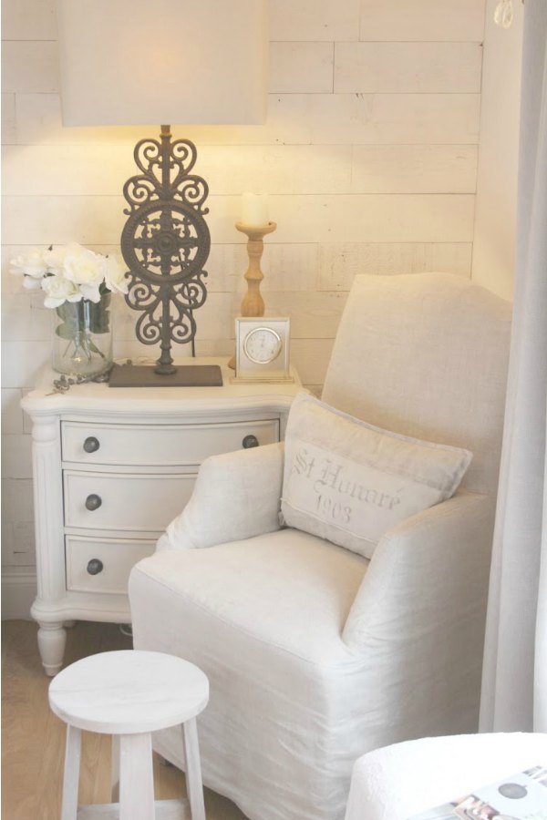 10 Tips to Decorate Without Spending a Dime! A Belgian linen slipcovered arm chair in my bedroom from RH. Cottage style nightstand with Paris gate lamp (RH) and Stikwood (Hamptons) reclaimed wood planks on wall for a rustic chic look. #bedroomdecor #neutral #stikwood #hamptons #belgianlinen #hellolovelystudio