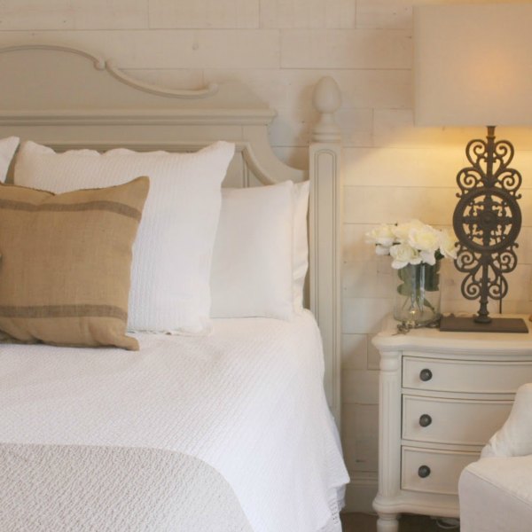 My French Nordic cottage style bedroom is a retreat with painted furniture (BM Revere Pewter), white oak flooring, rustic alder doors, and a reclaimed pine Stikwood statement wall. Hello Lovely Studio.