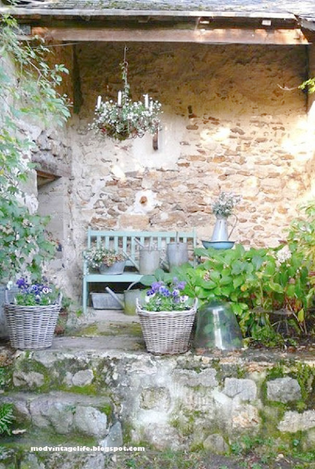 Lovely blue bench against a rustic stone wall. ModVintageLife. #frenchfarmhouse #frenchblue #Frenchgarden