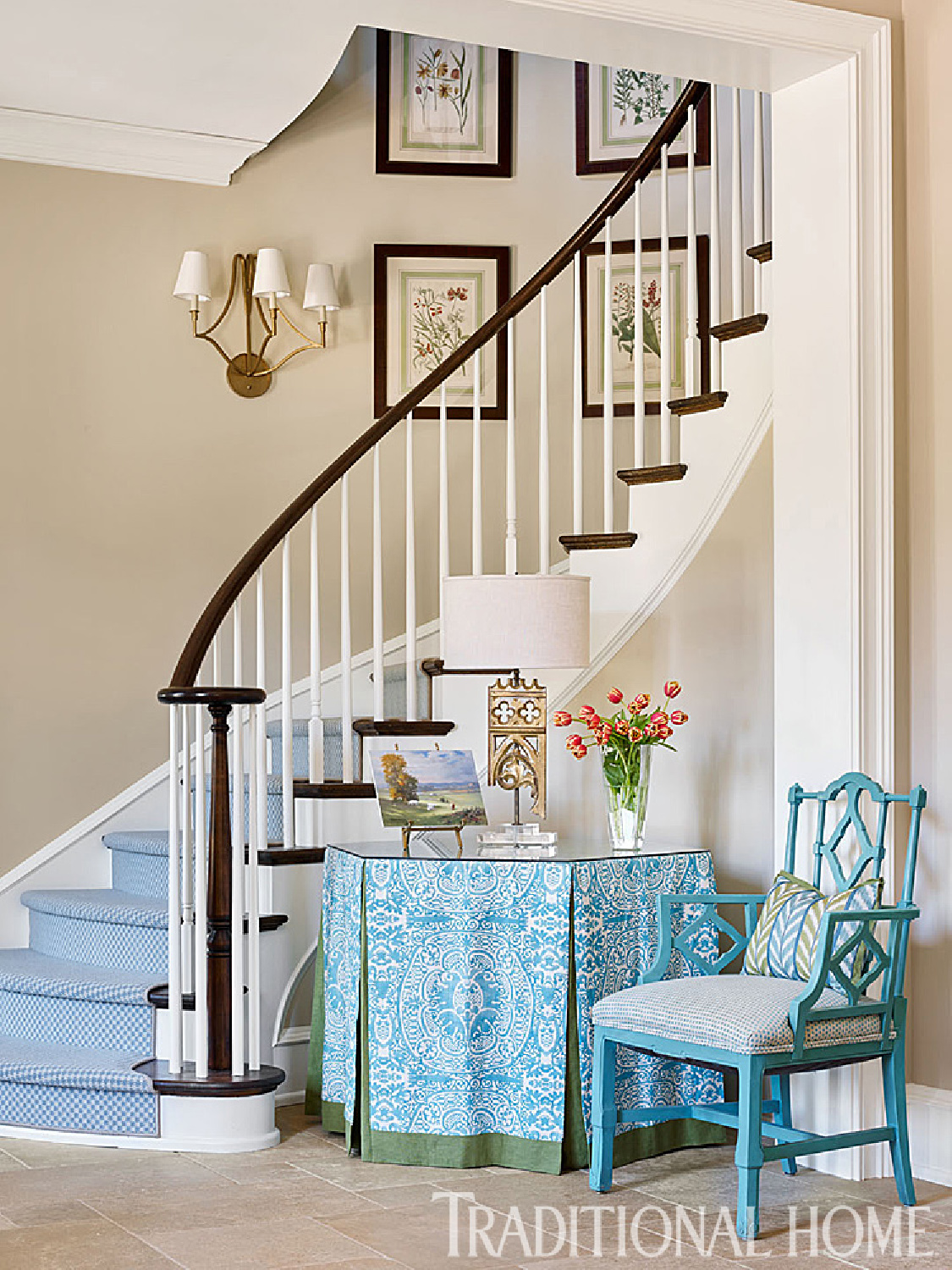 Turquoise skirted table and accents in a traditional entry with sculptural staircase - Traditional Home. #turquoise #foyers