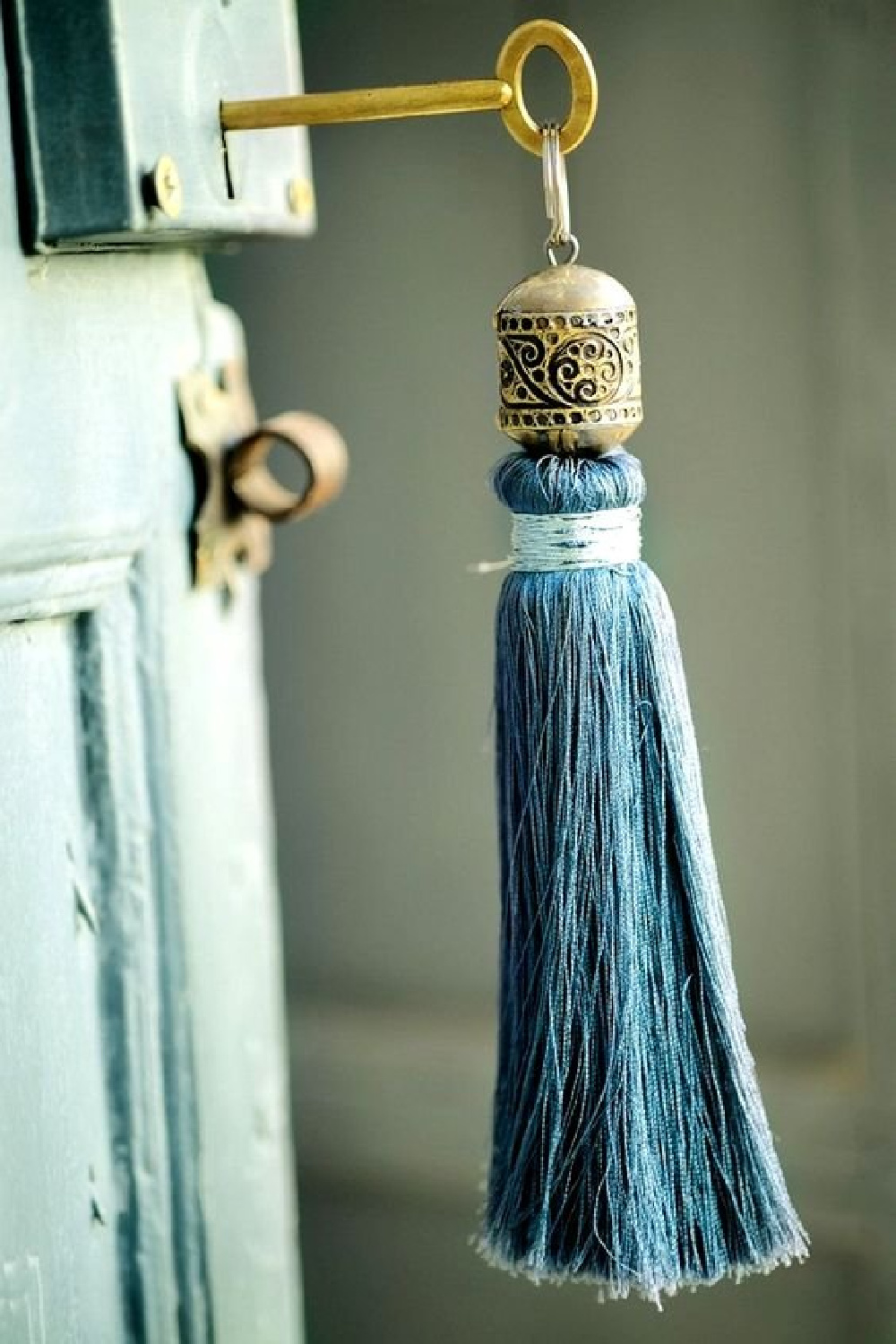 Turquoise tassel on a rustic painted cabinet - Amellye. #turquoise #tassels