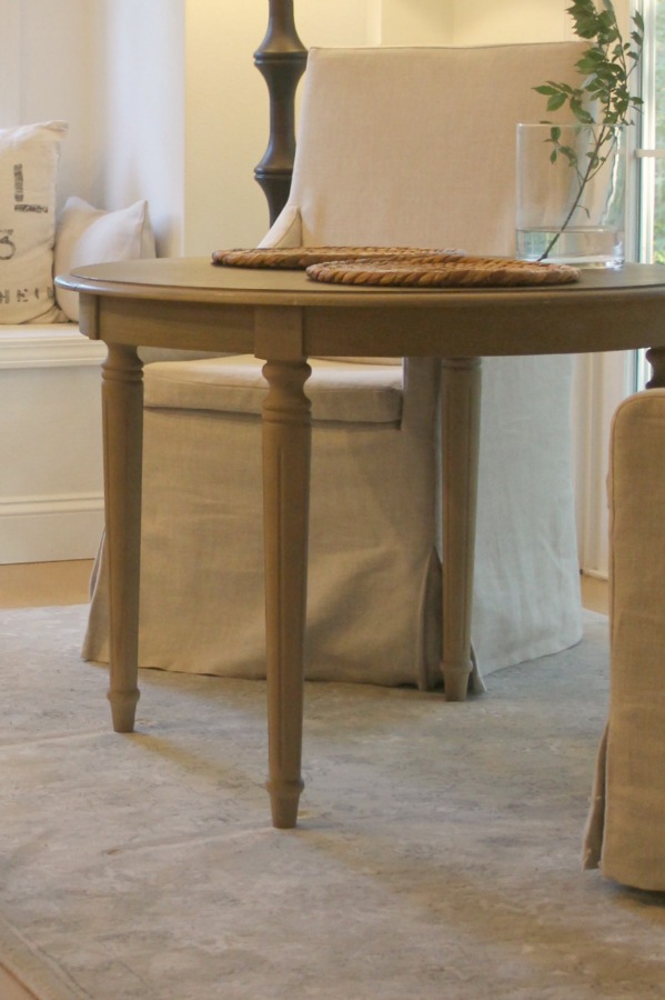 Breakfast room with round table and linen slipcovered chairs - Hello Lovely Studio. When You Need the Perfect Linen Slipcovered Chairs & Linen Upholstered Seating...certainly a lovely collection of options indeed.