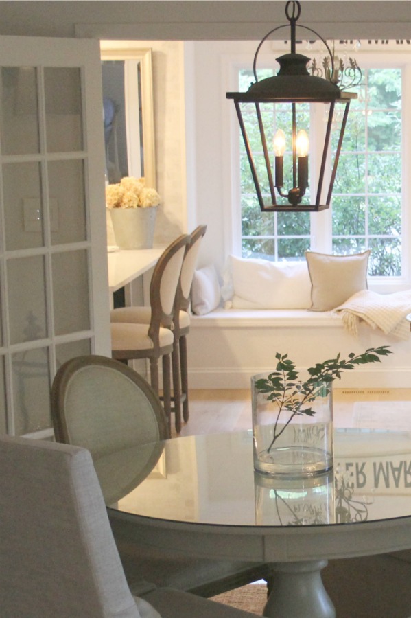 Dining room with European country style and farmhouse lantern - Hello Lovely Studio. When You Need the Perfect Linen Slipcovered Chairs & Linen Upholstered Seating...certainly a lovely collection of options indeed.