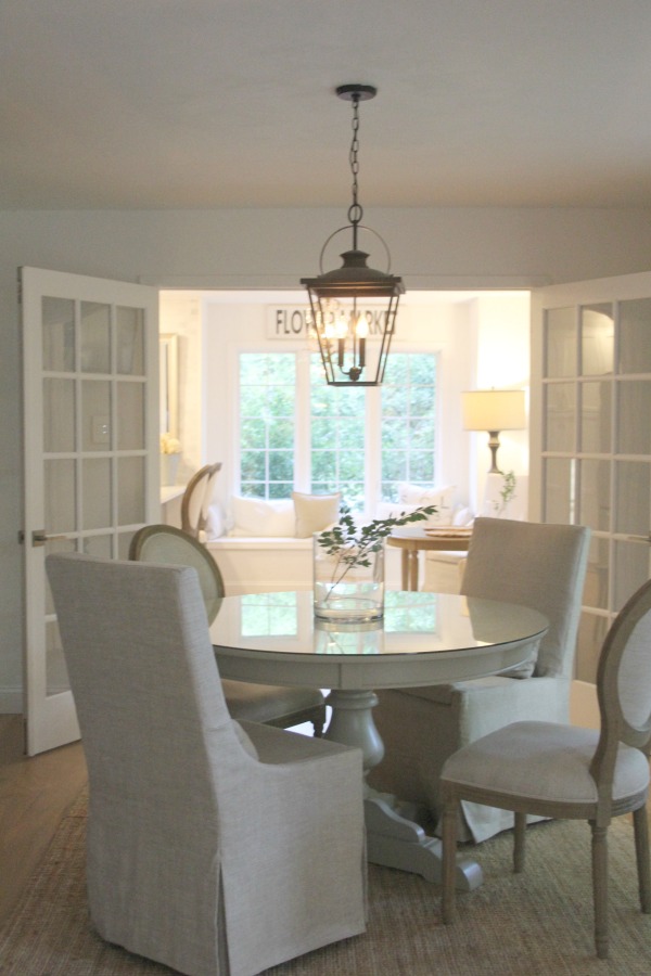 Dining room with round table and Belgian linen chairs. Hello Lovely Studio. #diningroom #hellolovelystudio