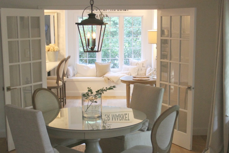 Dining room with round table and easy, simple, serene European country decor. Love Letter to Belgian Linen: The Loveliness of Living With Linen's Natural, Wabi Sabi Charm!