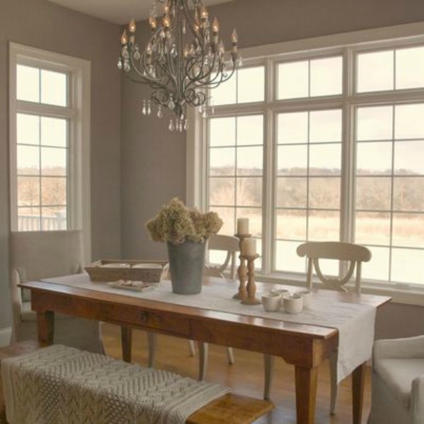 French country breakfast room with farm table, chandelier, bench and cableknit throw. Hello Lovely Studio.