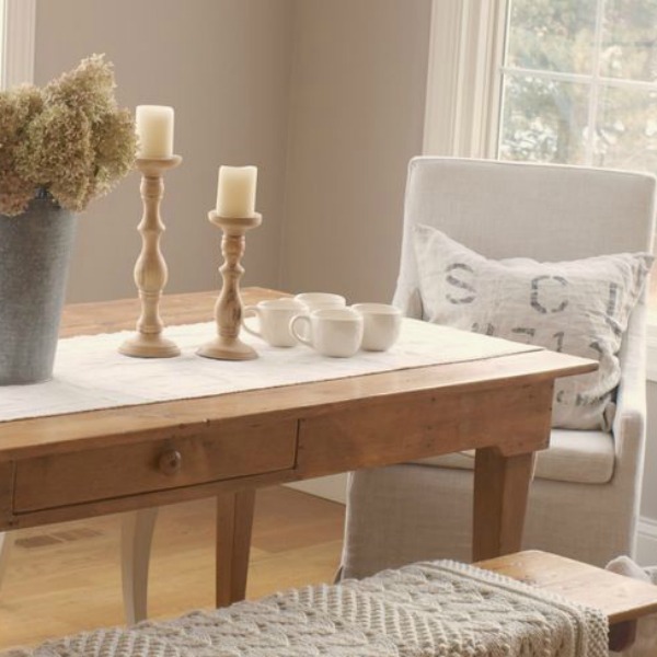 My rustic French farnhouse dining area with harvest table and Belgian linen upholstered chairs - Hello Lovely Studio.