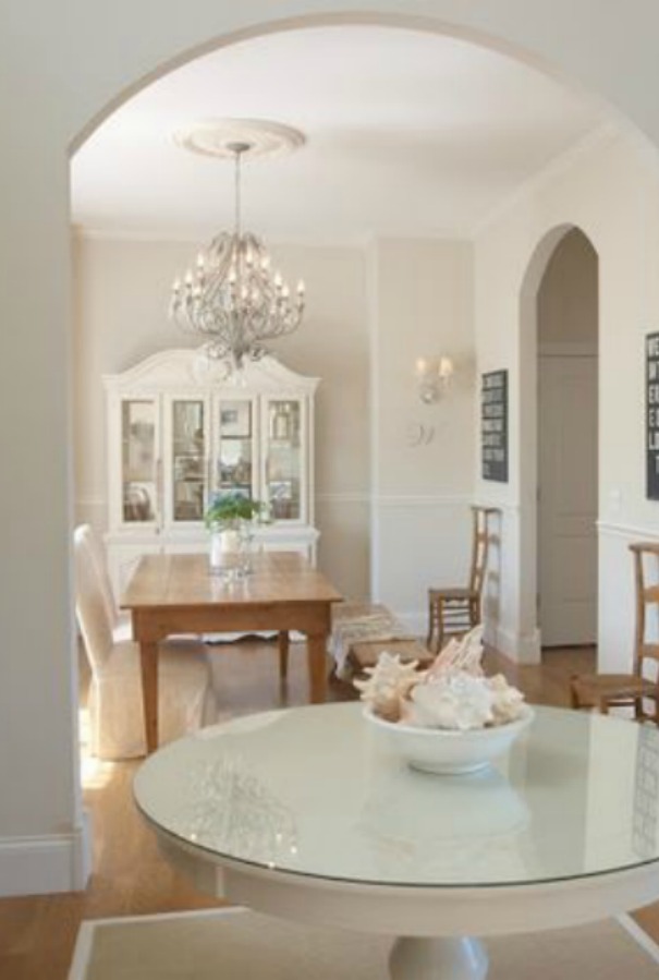 Foyer and dining room with wide arched doorway in our French country home. Hello Lovely Studio