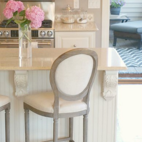 French country kitchen with beadboard clad island and decorative corbels. Hello Lovely Studio.