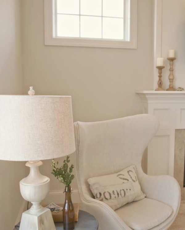 Tone on tone, Belgian linen, and French farmhouse decor play starring roles in my serene living room with Benjamin Moore White Sand painted walls. Hello Lovely Studio.