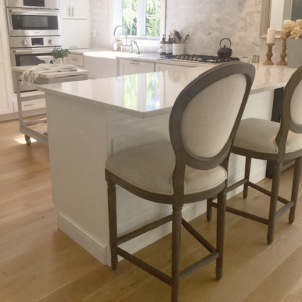Belgian linen covered counter stools in a Euro inspired kitchen by Hello Lovely Studio. Love Letter to Belgian Linen: The Loveliness of Living With Linen's Natural, Wabi Sabi Charm!