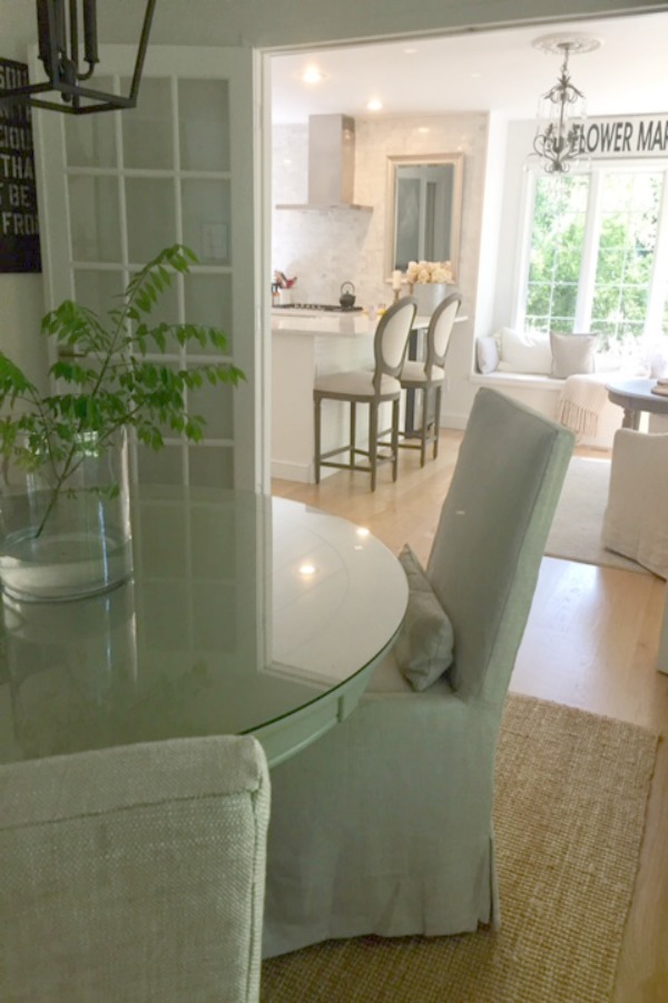 In our Lovely Tranquil Classic Kitchen is a mix of modern and vintage design elements. An industrial steel cart (painted Annie Sloan Paris Grey), Shaker cabinetry, marble subway tile backsplash, stainless pro appliances, fireclay farm sink, white oak hardwood flooring, and Viatera Minuet quartz on counters. #hellolovelystudio #whitekitchen #serenedecor #timelessdesign #modernfarmhouse #europeanfarmhouse #industrialcart #marblesubwaytile #whiteoak #viateraquartz #minuet #anniesloanparisgrey #steelcart