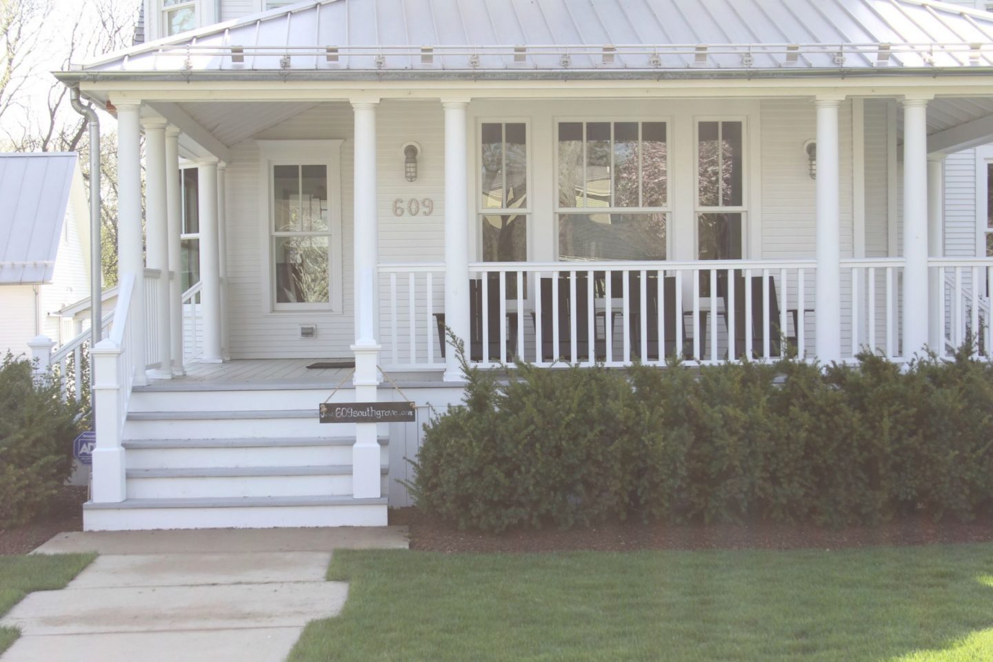 1875 Industrial Modern Farmhouse Tour. White modern farmhouse exterior with cedar siding, board and batten, metal galvalume roof, and black trim accents. Come see more! Photo by Hello Lovely Studio. #modernfarmhouse #exterior #whitefarmhouse #boardandbatten #housedesign #farmhousearchitecture #hellolovelystudio