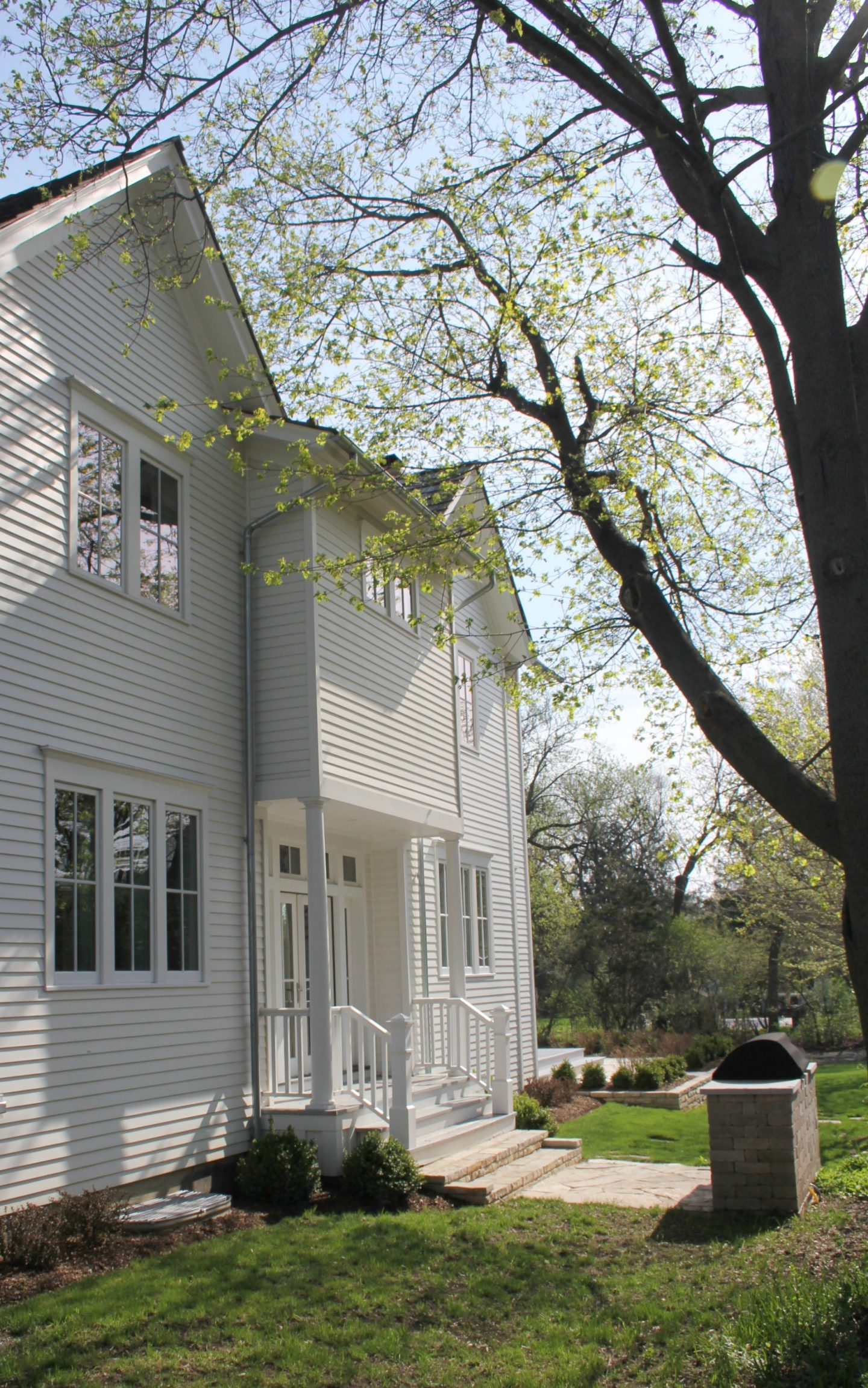 White modern farmhouse exterior with cedar siding, board and batten, metal galvalume roof, and black trim accents. Come see more! Photo by Hello Lovely Studio. #modernfarmhouse #exterior #whitefarmhouse #boardandbatten #housedesign #farmhousearchitecture #hellolovelystudio