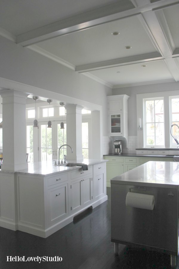 Modern farmhouse kitchen with two tone cabinetry, black granite, coffered ceiling, and industrial stainless work island. #helloloelystudio #kitchendesign #farmhousekitchen #modernfarmhouse #cofferedceiling