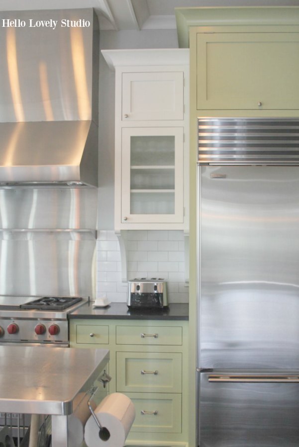 Industrial Chic Farmhouse Kitchen Inspiration with green cabinets, custom stainless island, and black stained flooring. #modernfarmhouse #kitchendesign #industrialfarmhouse #farmhousekitchen #benjaminmoorestoningtongray